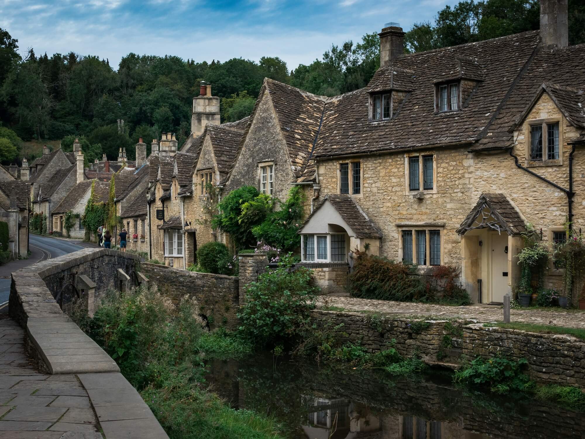 Cotswold stone cottages beside the By Brook in Castle Combe