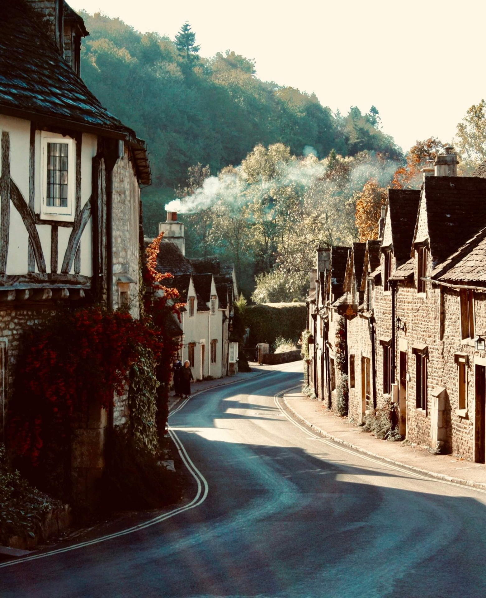 Morning light along the winding main street of Castle Combe